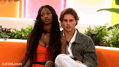 Man And Woman Sitting On Couch GIF