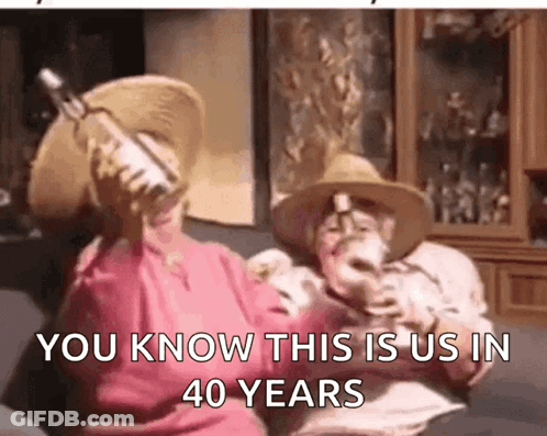 Man And Woman Sitting On Couch Holding Alcohol GIF