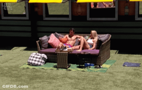 Man And Woman Sitting On Couch In Front Of Building Saying Liu GIF