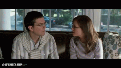 Man And Woman Sitting On Couch Looking At Each Other GIF