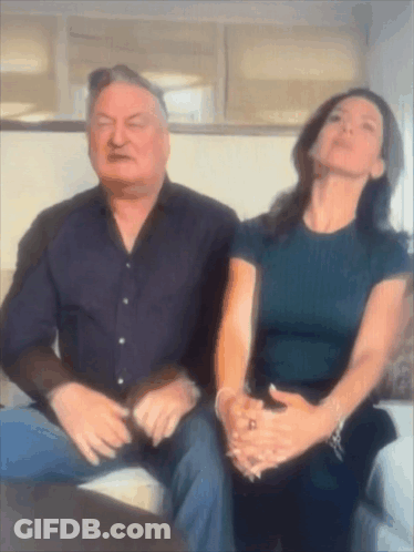 Man And Woman Sitting On Couch Looking Up GIF