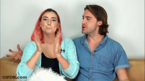 Man And Woman Sitting On Couch Pink Hair GIF