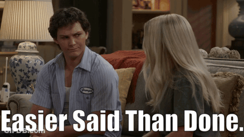 Man And Woman Sitting On Couch Saying Easier Said Than Done GIF