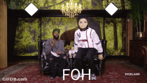 Man And Woman Sitting On Couch Saying Foh GIF