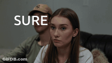 Man And Woman Sitting On Couch Saying Sure GIF