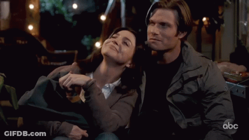Man And Woman Sitting On Couch With ABC Logo GIF