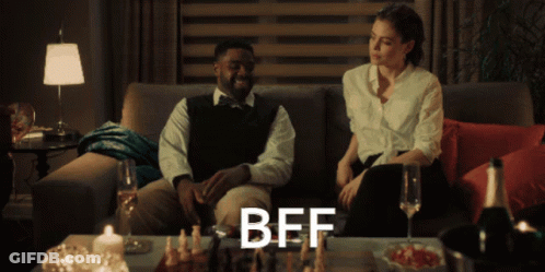 Man And Woman Sitting On Couch With BFF On Table GIF