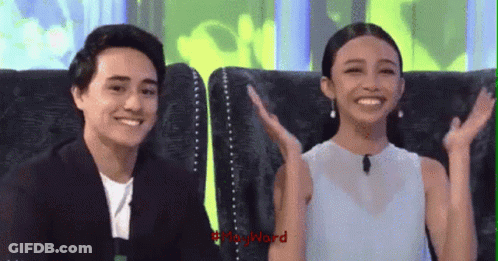 Man And Woman Sitting On Couch With Hands In Air GIF