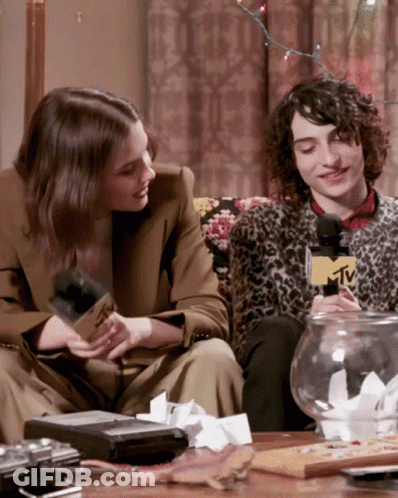 Man And Woman Sitting On Couch With MTV Microphone GIF