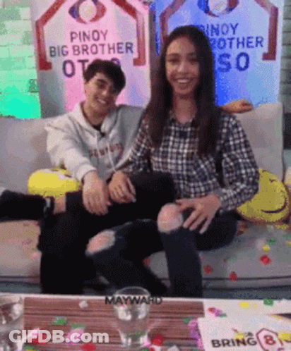 Man And Woman Sitting On Couch With Pinoy Big Brother Sign GIF