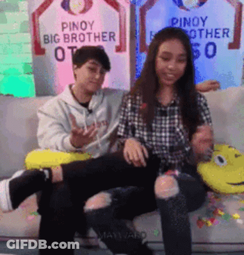 Man And Woman Sitting On Couch With Pinoy Big Brother Sign GIF