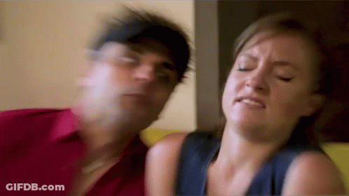 Man And Woman Sitting On Couch Woman Making Face GIF