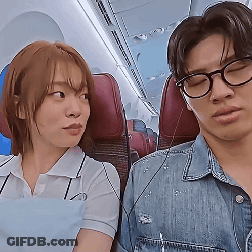 Man And Woman Sitting On Plane GIF