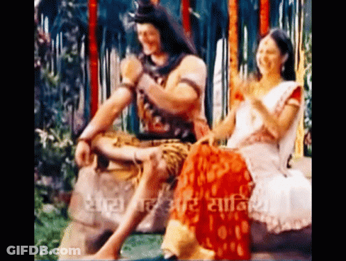 Man And Woman Sitting On Rock GIF