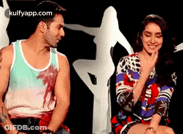 Man And Woman Sitting On Stage GIF