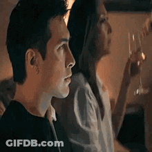 Man And Woman Sitting Together In Dark Room GIF