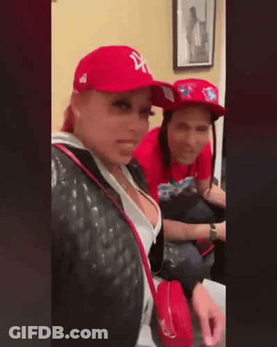 Man And Woman Sitting Together In Red Hats GIF