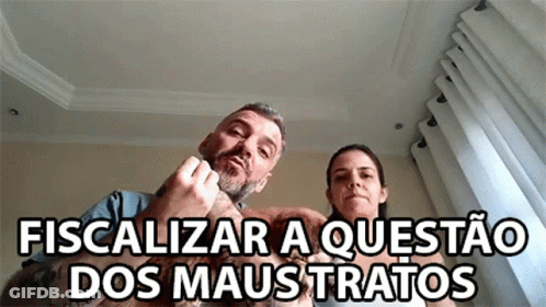 Man And Woman Sitting With Dog Fiscalizar A Questão Dos Maus Tratos GIF