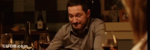 Man And Woman Sitting With Wine Glasses GIF