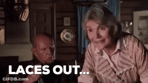 Man And Woman Sitting Woman Smiling Says Laces Out GIF