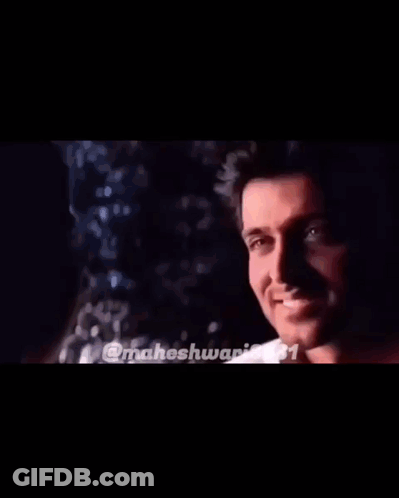Man And Woman Smiling At Each Other In Dark Room GIF
