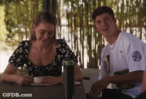 Man And Woman Smiling At Table GIF