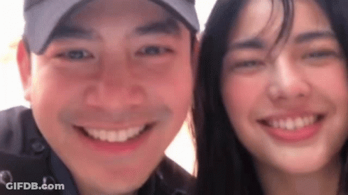 Man And Woman Smiling For Photo GIF
