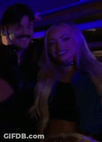 Man And Woman Smiling In Dark Room GIF