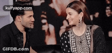 Man And Woman Smiling Sitting Together GIF