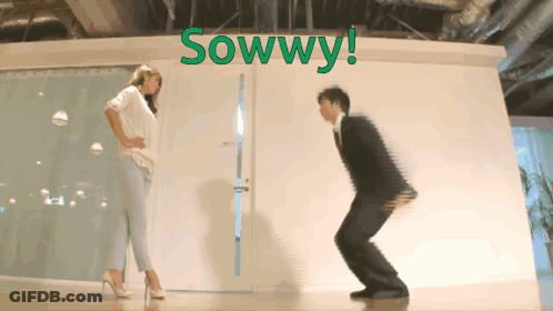Man And Woman Squatting In Front Of Sowwy Wall GIF