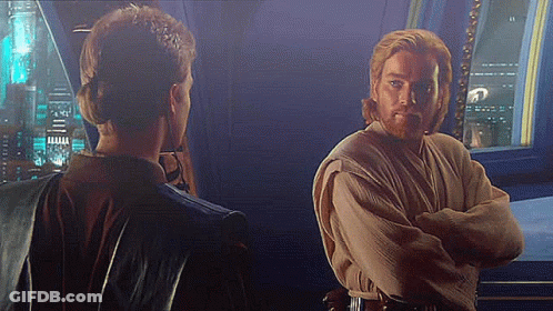 Man And Woman Standing Arms Crossed Looking At Each Other GIF