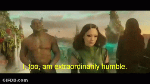 Man And Woman Standing As Woman Says I Too Am Extraordinarily Humble GIF
