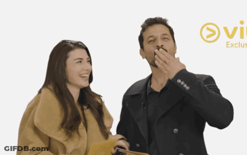 Man And Woman Standing At Ovi Exclus Sign GIF
