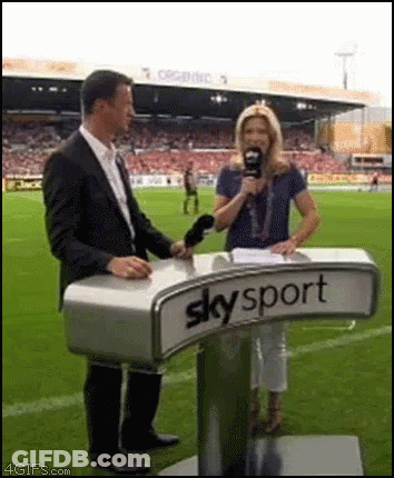 Man And Woman Standing At Skysport Podium GIF