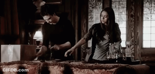 Man And Woman Standing At Table GIF
