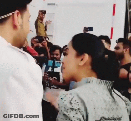Man And Woman Standing Before Crowd GIF