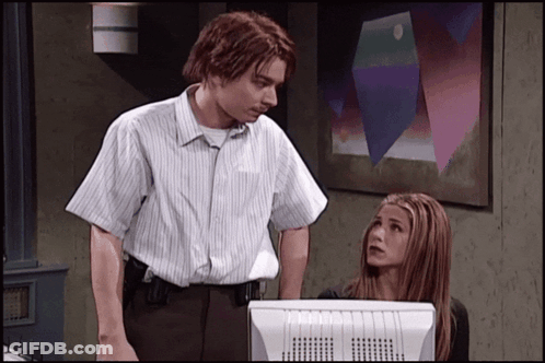 Man And Woman Standing By Computer Monitor GIF
