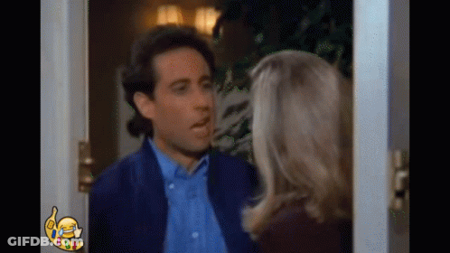 Man And Woman Standing By Door GIF