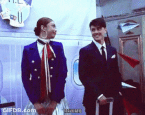 Man And Woman Standing By Heyward Sign GIF