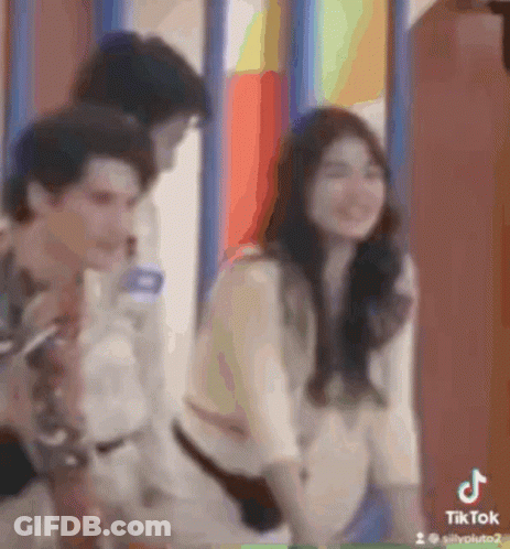 Man And Woman Standing By Window GIF