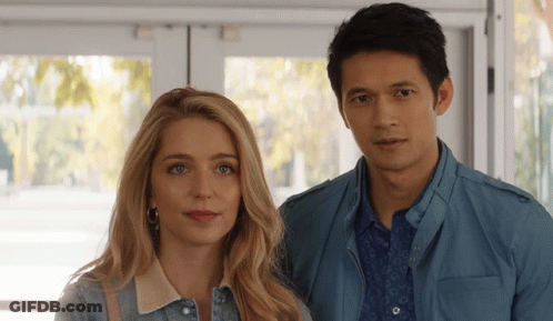 Man And Woman Standing By Window GIF