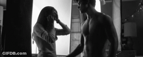 Man And Woman Standing By Window GIF