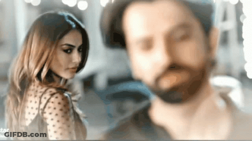 Man And Woman Standing In Blurry Photo GIF