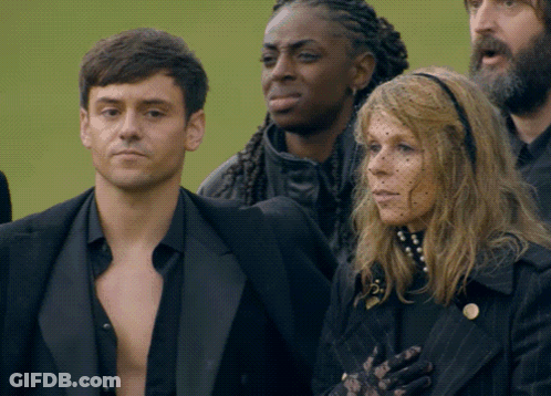 Man And Woman Standing In Crowd GIF