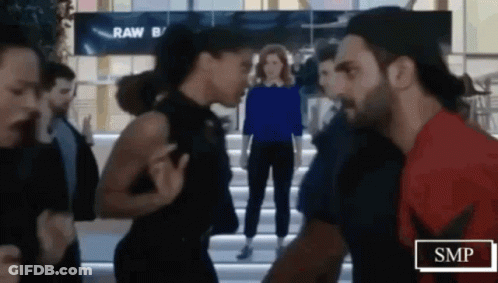 Man And Woman Standing In Crowded Area GIF