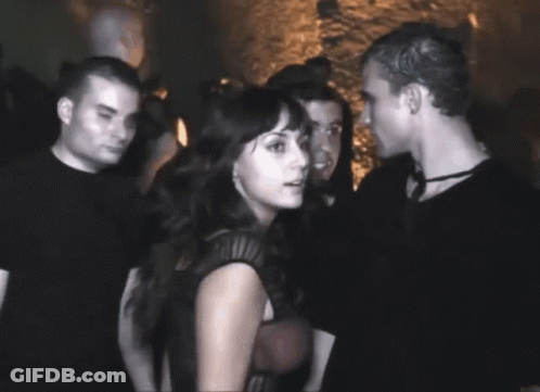Man And Woman Standing In Crowded Room GIF