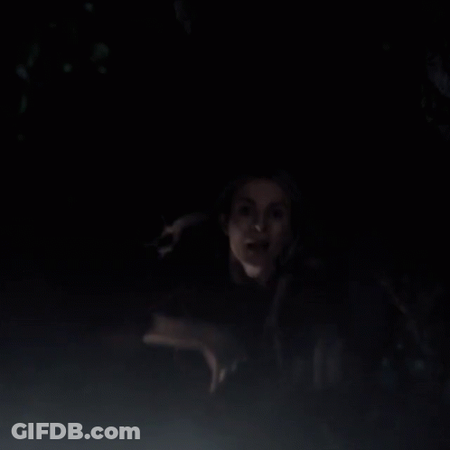 Man And Woman Standing In Dark Looking At Something GIF