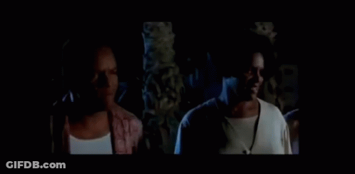Man And Woman Standing In Dark Room GIF