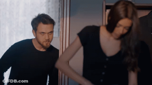 Man And Woman Standing In Dark Room GIF
