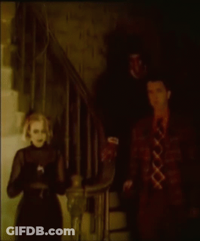 Man And Woman Standing In Dark Room GIF